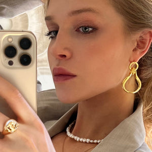 model wearing ÉMILLIE ANNE tusk earrings