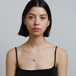 Model wearing gold necklace