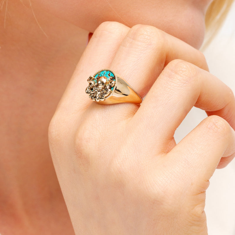 Model with gold octopus ring