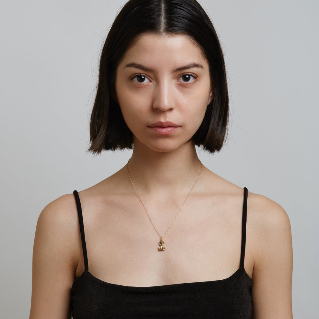 Model wearing gold necklace